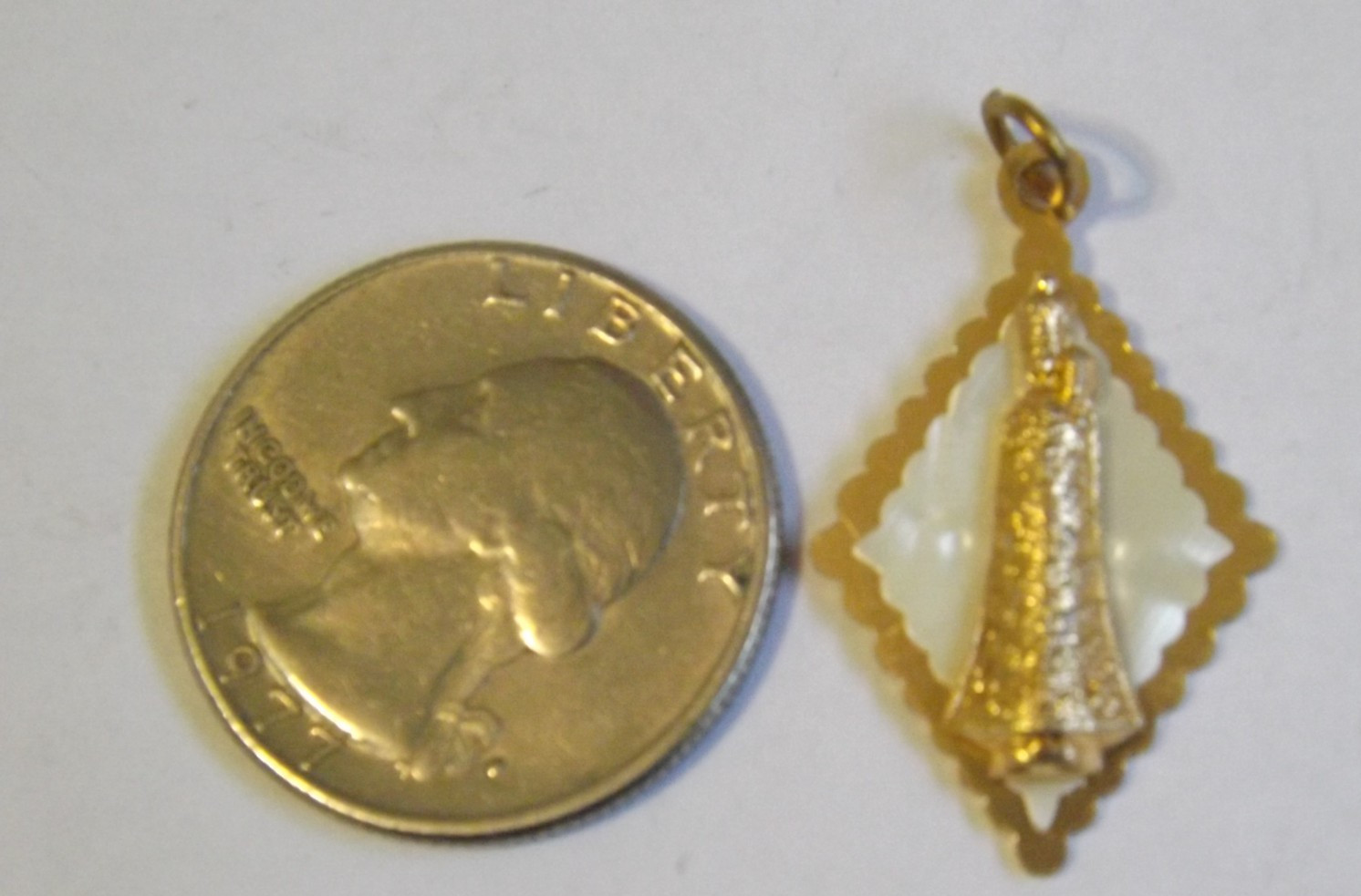 Lightweight gold tone faux mop plastic Our Lady of Loreto pendant medal